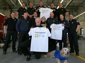 Emily Mountney-Lessard/The Intelligencer
Belleville Fire Department deputy fire chief Ray Ellis, along with members of the fire department, shows support for the Canadian Cancer Society at Station 1 on Wednesday. Also shown is Canadian Cancer Society volunteer Karen White and her dog, Lucy.