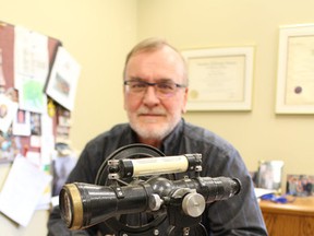 County engineer Jim Kutyba is pictured here with a theodolite -- a surveying instrument -- he keeps in his office. Kutyba, the county's general manager of infrastructure and development services, will retire at the end of next month following a 26-year career in public service. (Barbara Simpson/Sarnia Observer/Postmedia Network)