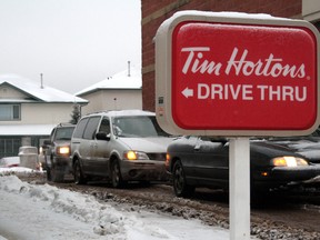 Vehicles line up at the Tim Hortons drive-thru in Fort McMurray, Alta., in this Jan, 10, 2012 file photo. (MORGAN MODJESKI/Postmedia Network)