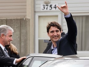 Prime Minister Justin Trudeau waves goodbye after visiting the Family Futures Resource Network, 3756 - 78 St., in Edmonton Alta. on Wednesday March 30, 2016. Photo by David Bloom