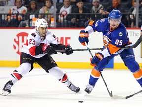 New York Islanders centre Brock Nelson skates with the puck as Ottawa Senators centre Scott Gomez defends during second-period NHL action at Barclays Center in Brooklyn on March 23, 2016. (Brad Penner/USA TODAY Sports)