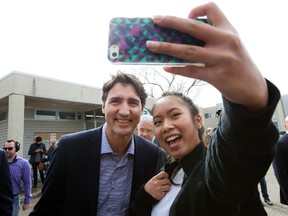 Prime Minister Justin Trudeau poses for photos in Edmonton before visiting the Family Futures Resource Network on Wednesday, March 30, 2016. (David Bloom/Postmedia Network)