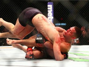 Nate Diaz applies a chokehold to Conor McGregor during UFC 196 at MGM Grand Garden Arena. (Mark J. Rebilas/USA TODAY Sports)