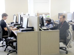 Local patrons use the computers at the local library, which will soon embark on a project to build a dedicated room for community programs behind the hub's computers area. File photo.