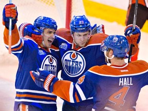 Edmonton Oilers' Nail Yakupov (10), Leon Draisaitl (29) and Taylor Hall (4) celebrate a goal against the Anaheim Ducks during third period NHL action in Edmonton, Alta., on Monday March 28, 2016. THE CANADIAN PRESS/Jason Franson