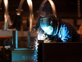 A welder works in a factory in Quebec City in this Feb. 28, 2012 file photo. (THE CANADIAN PRESS/Jacques Boissinot)