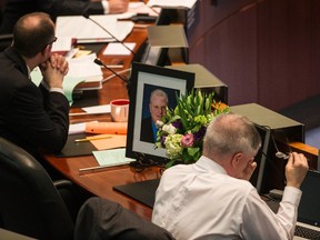 Flowers and a portrait of Rob Ford are placed at his empty seat in council chambers at Toronto City Hall on Thursday, March 31, 2016. (Craig Robertson/Toronto Sun)