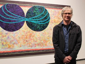 Plympton-Wyoming artist Gary Spearin is pictured here with one of the works in his "OO Paintings" exhibit set for the Judith & Norman Alix Art Gallery. He and Quebec artist Diane Landry, whose work will also be on display, met with media Thursday ahead of their exhibits opening to the public Friday. (Barbara Simpson, The Observer)