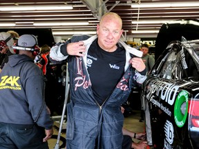 Derek White, a member of the Mohawk tribe from Kahnawake, Que., exits his garage after practice for the NASCAR 5-Hour Energy 301 auto race at New Hampshire Motor Speedway in Loudon, N.H., on July 17, 2015. White, who became the first Native American to start a Sprint Cup race, was charged with smuggling tobacco into Canada from the U.S. (Cheryl Senter/AP Photo/Files)