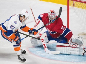 Montreal Canadiens goaltender Carey Price makes a save on New York Islanders’ Anders Lee during NHL action in Montreal Sunday, November 22, 2015. (THE CANADIAN PRESS/Graham Hughes)