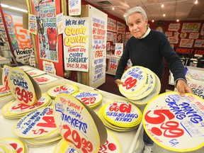 Sign painter Douglas Kerr has been painting signs for Honest Ed's for over 20 years and displays one of them Thursday March 31, 2016 in Toronto. Honest Ed's holds a sign sale on Saturday, April 2 and Sunday April 3, 2016.Veronica Henri/Toronto Sun/Postmedia Network