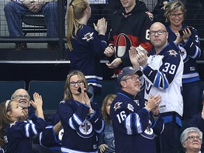 Winnipeg Jets fan favourite Len Kropioski (top centre) reacts as fans salute his return to the MTS Centre as the Jets took on the Ottawa Senators in Winnipeg on Wed., March 30, 2016. Kroppy had been in hospital in his hometown of Kenora. Kevin King/Winnipeg Sun/Postmedia Network