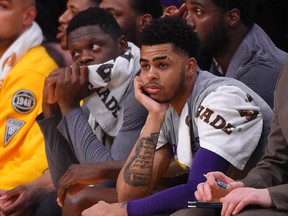 Lakers guard D'Angelo Russell (right) sits on the bench next to forward Julius Randle during first half NBA action against the Heat in Los Angeles on Wednesday, March 30, 2016. (Mark J. Terrill/AP Photo)