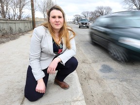 CAA Manitoba spokeswoman Erika Miller is pictured on a pock-marked section of Empress Street in Winnipeg on Thu., March 31, 2016. Empress currently ranks 10th in CAA's top 10 worst roads in Manitoba voting.