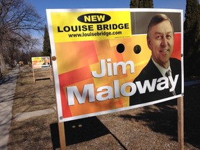 The sticker says "New Louise Bridge" and includes a website where people can get more information about why plans to replace the bridge have been put on hold by city hall.