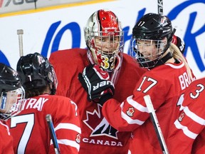 Team Canada goaltender Charline Labonte is congratulated by teammates after defeating Russia at the women's world hockey championships in Kamloops, B.C., on March 29, 2016. (THE CANADIAN PRESS/Ryan Remiorz)
