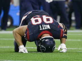 Houston Texans defensive end J.J. Watt (99) stays down after he was injured during an NFL wild-card playoff game against the Kansas City Chiefs, Saturday, Jan. 9, 2016, in Houston. (AP Photo/Tony Gutierrez)