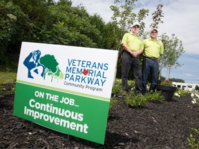 Veterans Memorial Parkway Community Program executive director Barry Sandler, left, and horticulturalist Paul Gagnon, right, show off a small scale version of the living memorial garden that will be planted on a boulevard leading into the Canadian National Vimy Memorial in Vimy, France.  The garden, which will be planted with the help of Canadian scouts, will include several varieties of maple trees, white roses, as well as a variety of blue and red flowers.  The pair are pictured here at the side of Veterans Memorial Parkway in London, Ont. on Thursday August 13, 2015. Craig Glover/The London Free Press/Postmedia Network