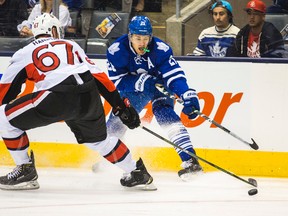 Toronto Maple Leafs forward James van Riemsdyk tries to evade Ottawa Senators defenceman Ben Harpur during preseason action in Toronto on Monday September 21, 2015. (Ernest Doroszuk/Toronto Sun/Postmedia Network)