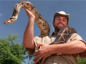 Paul "Little Ray" Goulet shown in this file photo holding a boa constrictor. JEFF BASSETT / JEFF BASSETT, OTTAWA SUN