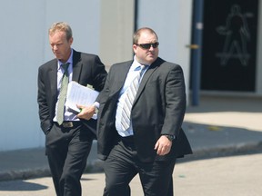 The Ontario Civilian Police Commission has upheld the firing of Durham cop Glen Turpin (Right), who had been suspended with pay for the past eight years. File pic. (Jack Boland/Toronto Sun/Postmedia Network)
