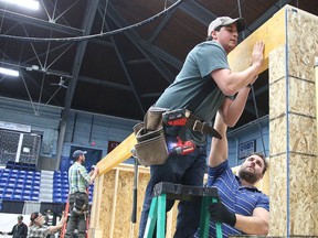 Mark Zagordo and Trevor Berzins of SLV Homes put a beam in place while building a mock-up of a home at the Sudbury & District Homebuilders Homeshow at the Sudbury Community Arena in Sudbury, Ont. on Thursday March 31, 2016. The show runs from April 1 to 3 at the Sudbury Community Arena. Gino Donato/Sudbury Star/Postmedia Network