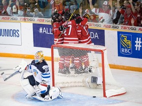 Team Canada players celebrate a goal as Finland goaltender Meeri Raisanen looks on during second period action at the women's world hockey championships in Kamloops, B.C., March 31, 2016. (THE CANADIAN PRESS/Ryan Remiorz)