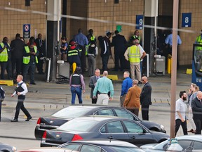Police and rescue officials gather alongside bus patrons outside the Greyhound Bus Station in Richmond, Va., on March 31, 2016. (AP Photo/Steve Helber)