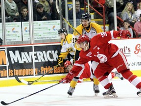 Soo Greyhounds centre Hayden Verbeek reaches for the puck while being shadowed by Sarnia Sting winger Jordan Kyrou during first-period action Thursday, March 31, 2016 in Game 4 of the OHL Western Conference quarter-final at the Essar Centre in Sault Ste. Marie, Ont. JEFFREY OUGLER/SAULT STAR/POSTMEDIA NETWORK