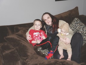 Jeanine Perry sits with her children, Austin and Declan. She has organized a meet-up group for families with high needs children in the tri-area. - Photo by Marcia Love
