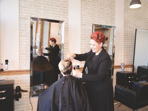 Vanity Collective owner Lindsey Gorgichuk cuts salon co-ordinator Noel Bunten’s hair on March 29. The salon has been very busy since its doors opened on March 24. - Photo by Marcia Love