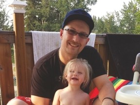 Adam Tarnowski is shown with his daughter in this undated photo. The Onoway man received the Carnegie Medal (left) for his bravery in pulling a young man from a burning vehicle in July 2014. - Photo supplied