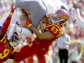Linebackers Anthony Lazard #53 and Reggan Northrup #9 of the Iowa State Cyclones combine on a tackle in the second half on wide receiver Derrick Neal #7 of the Kansas Jayhawks on October 3, 2015 at Jack Trice Stadium, in Ames, Iowa.  (Matthew Holst/Getty Images/AFP)