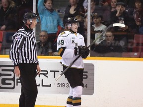 Linesmen John Fischer skates Knights forward Max Jones off the ice for a blindside hit on the Attack's Justin Brack during OHL playoff action in Owen Sound, Ont., on Monday, March 28, 2016. The OHL suspended Jones 12 games on Friday, April 1 for the hit. (James Masters/Postmedia Network)