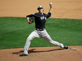 Yankees' Andrew Miller pitches against the Braves in a spring training game in Kissimmee, Fla., on Wednesday, March 30, 2016. Miller, who was struck on the right arm by a line drive after the pitch, can continue to play and won't need surgery on a broken bone on his wrist. (John Raoux/AP Photo)