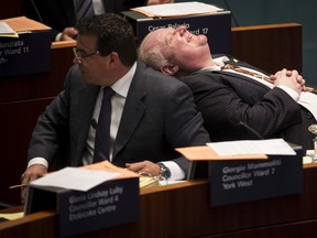 Then-Toronto mayor Rob Ford laughs during a city council meeting beside Councillor Giorgio Mammoliti in this file pic from Nov. 14, 2013. (REUTERS/Mark Blinch/Files)