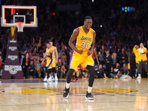Los Angeles Lakers forward Julius Randle, front, celebrates as the Lakers defeat the Miami Heat in overtime in an NBA basketball game, Wednesday, March 30, 2016, in Los Angeles. The Lakers won 102-100. (AP Photo/Mark J. Terrill)