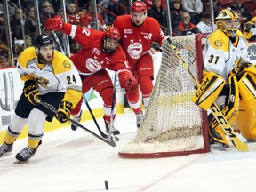Sarnia Sting defenceman Kevin Spinozzi pursues the puck, followed by Soo Greyhounds wingers Boris Katchouk (12) and Tim Gettinger, as Sting goaltender Charlie Graham guards his net during Game 4 on Thursday, March 31, 2016 in Sault Ste. Marie, Ont. Game 5 is Saturday at 7:05 p.m. in Sarnia. (JEFFREY OUGLER, Postmedia Network)
