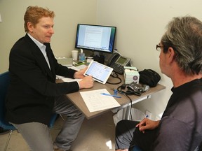 Dr. Danial Schecter, Executive Director of CMClinic, attends to patient Bob Landry,  on Thursday, July 17, 2014, at the CMClinic-Toronto's first referral-only medical marijuana clinic. Edmonton is set to get one in mid-April, 2016. (Veronica Henri)