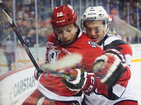 Stephen Harper of the Niagara IceDogs and Ryan Orban of the Ottawa 67s fight for the puck in OHL playoff action at the Meridian Centre in St. Catharines on Friday, April 1, 2016. (Julie Jocsak/St Catharines Standard/ Postmedia Network)