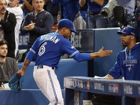 Marcus Stroman (left) of the Toronto Blue Jays is congratulated by David Price as he is relieved against the Kansas City Royals during Game 3 of the American League Championship Series at Rogers Centre on October 19, 2015. (Tom Szczerbowski/Getty Images/AFP)