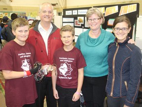 The members of the McAllister family gather at the school science fair at McArthur Hall in Kingston, Ont. on Friday, April 1, 2016. From left they are Connor, Dennis, Liam, Jenn and Caitlin. The parents, Jenn and Dennis, are judges this year. Michael Lea The Whig-Standard Postmedia Network