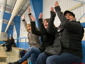 Three hockey moms from Kitchener ? Julie Beemer, left, June Donat and Kathy Beckett ? whoop it up Friday as their team scores early in its midget game at the house league hockey tournament being held this weekend in London. (MIKE HENSEN, The London Free Press)