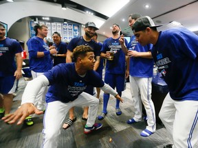The Blue Jays celebrate clinching the AL wild card after their win against Tampa Bay Rays at the Rogers Centre in Toronto, Ont. on Saturday September 26, 2015. (Stan Behal/Toronto Sun/Postmedia Network)