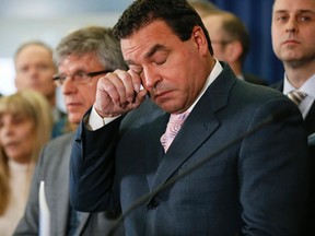 Councillor George Mammoliti is overcome as Mayor John Tory speaks to the media after the announcement of Councillor Rob Ford's death on March 22. (Stan Behal/Toronto Sun/Postmedia Network)