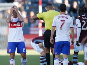 TFC's Benoit Cheyrou holds his head after picking up his second yellow card last night in Commerce City, COLO. (AP)