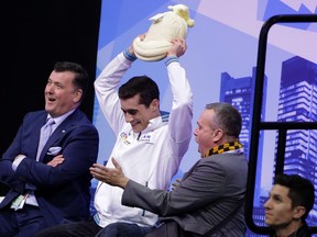 Javier Fernandez (centre) of Spain reacts with his coach Brian Orser (left) after winning gold in the men’s free skate on Friday. (AP)