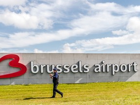 A policeman patrols at Brussels Airport, in Zaventem, Belgium, Sunday, April 3, 2016. (AP Photo/Geert Vanden Wijngaert)