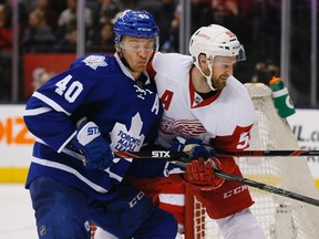 Leaf Michael Grabner tangles with Red Wings Niklas Kronwall in the third period, as the Toronto Maple Leafs take on the Detroit Red Wings at the Air Canada Centre in Toronto Saturday April 2, 2016. Stan Behal/Toronto Sun/Postmedia Network