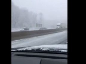 A car going the wrong way is seen passing other vehicles on Hwy. 401 near Kitchener Sunday, April 2, 2016. (Facebook video screengrab)